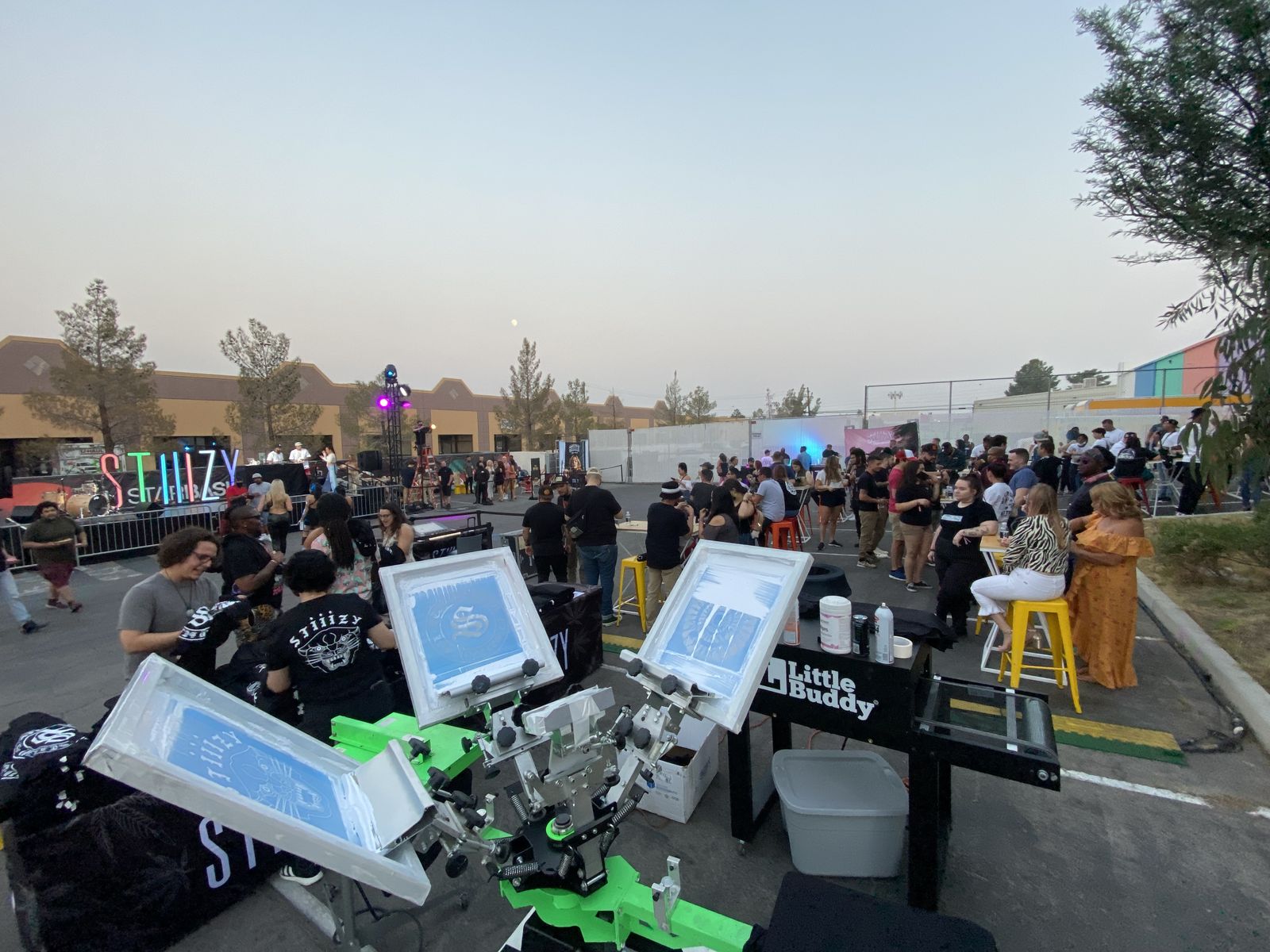 Outdoor evening party with a live printing station set up in the foreground