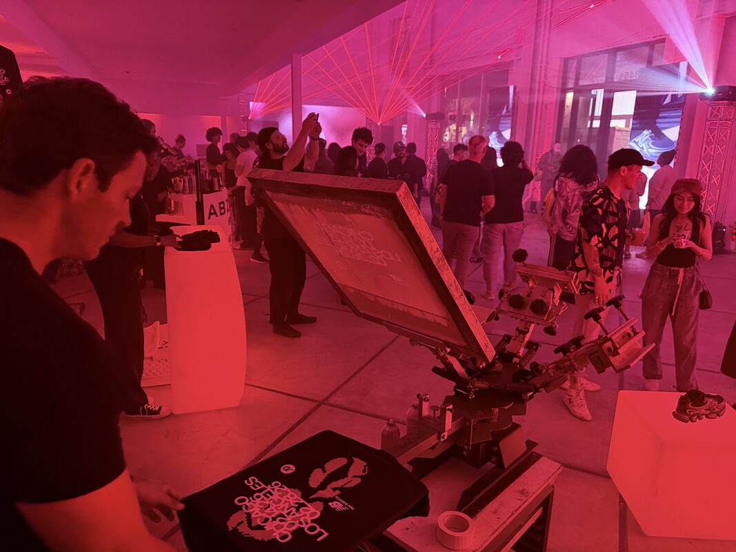 Live customization station glowing under red lighting at a night event